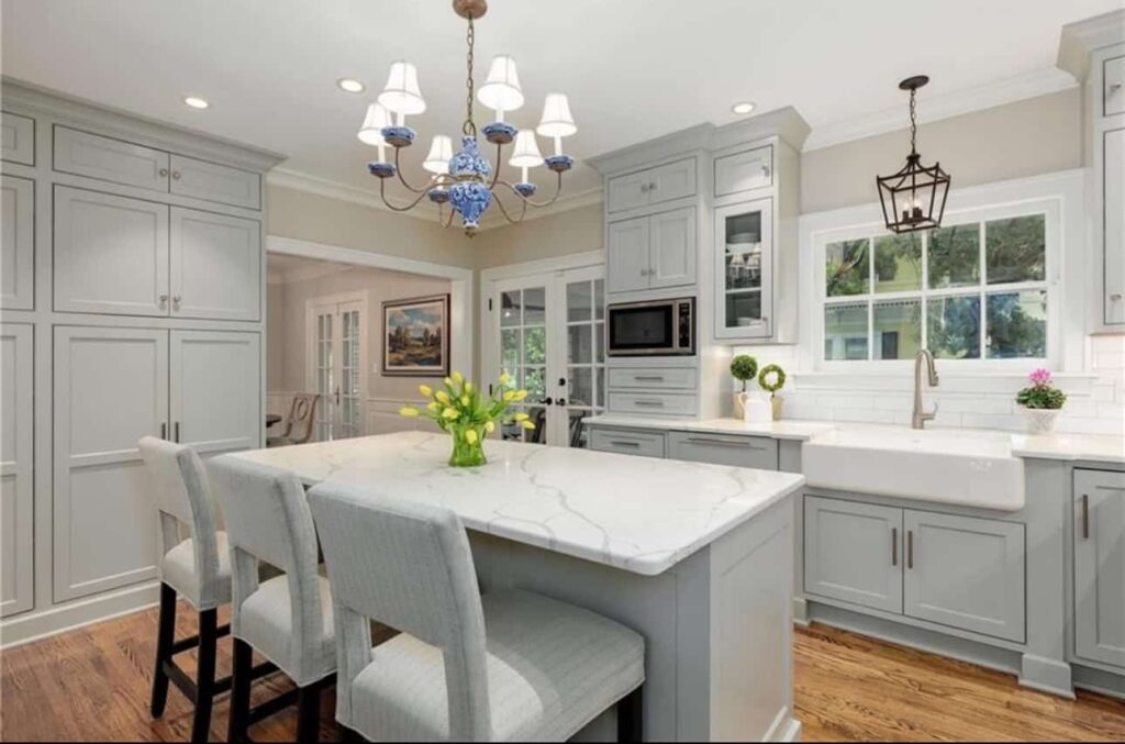 Modern kitchen with center island and light gray cabinets.